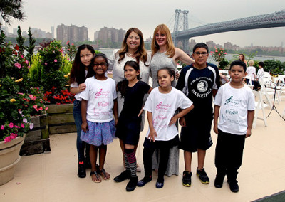 Anna Stampfli with Executive Superintendent of NYC, Dolores Esposito and District Orchestra students